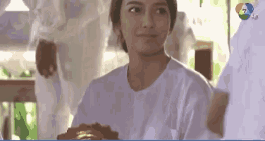 a woman wearing a white shirt with the number 7 on the bottom