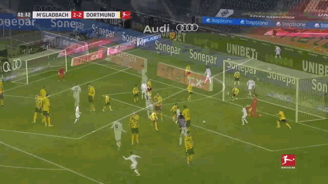 a soccer game is being played between mgladbach and dormund