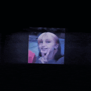 a girl giving a peace sign with her finger