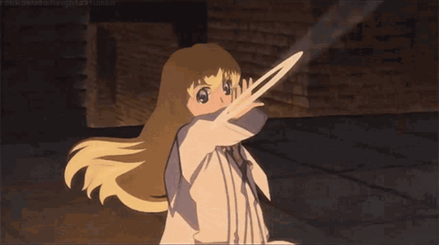 a girl with blonde hair is holding a ring with the letter c in it