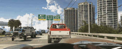 a red truck is driving down a highway with a green sign that says airport