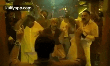 a group of people are dancing together in a room .