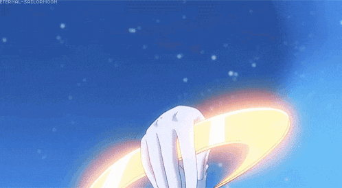 a person 's hand is holding a ring in the air .