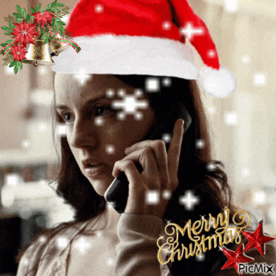 a woman wearing a santa hat is talking on her phone