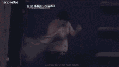 a shirtless man stands in front of a screen that says " vagonettas " on it