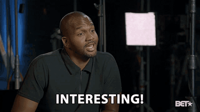 a man in a black shirt says " interesting "