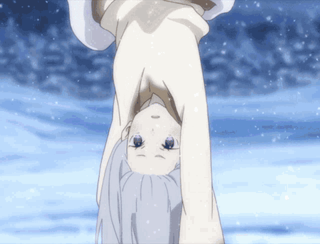 a girl is upside down in the snow and looking at the camera