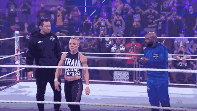 a woman in a wrestling ring with a shirt that says train on it