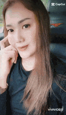 a woman with long hair is sitting in the back seat of a car .