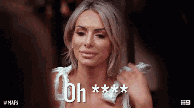 a woman in a white dress says oh *** on the screen