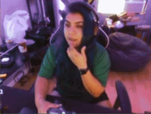 a woman with blue hair is wearing headphones