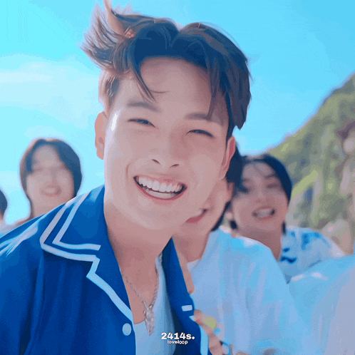 a young man in a blue shirt is smiling with the number 24145 on the bottom right