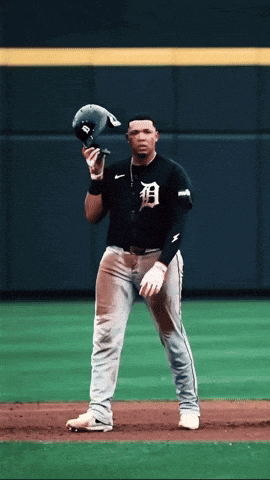 a baseball player wearing a black jersey with the letter b on it