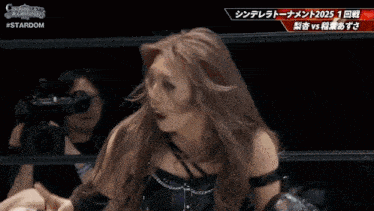 a woman in a wrestling ring with the words stardom on the top