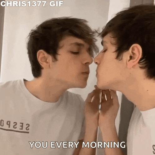 a man is kissing his reflection in a mirror while wearing a shirt that says chris 1377