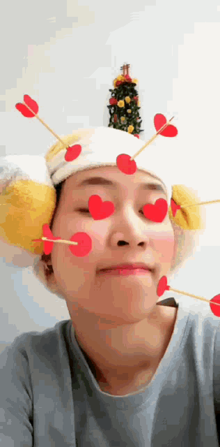 a woman wearing a headband with hearts on her face