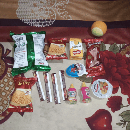 a bunch of snacks on a bed including one that says french