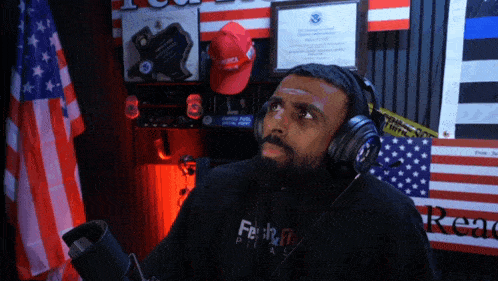 a man wearing headphones and a hoodie that says freak off