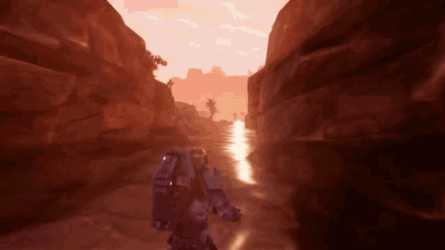 a robot is walking through a canyon with a river in the background