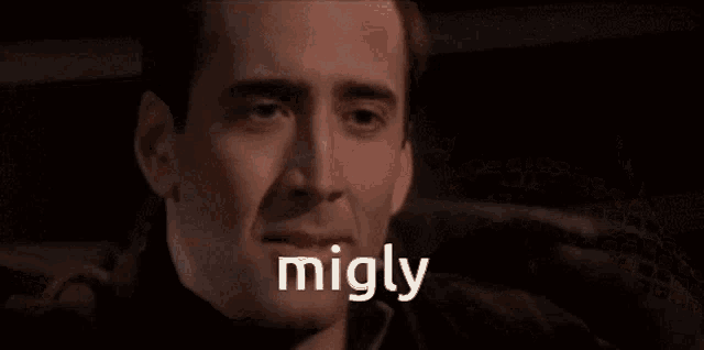 a close up of a man 's face with the word migly written above it .