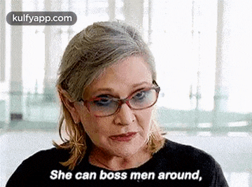 a woman wearing glasses and a black shirt is talking to a man .