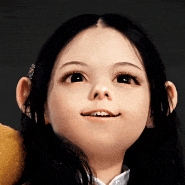 a little girl with long black hair is smiling