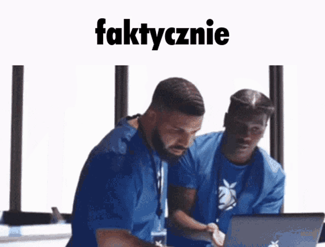 two men are looking at a laptop with the word faktycznie on the bottom