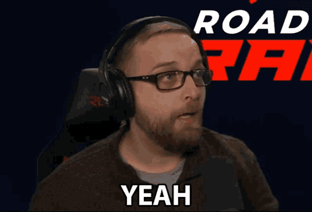 a man wearing headphones and glasses says yeah in front of a road rage logo