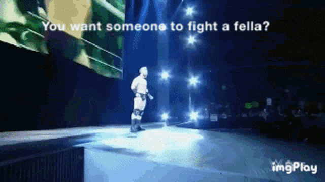 a man on a stage with the words " you want someone to fight a fella " on the bottom
