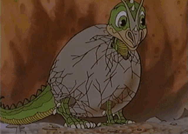 a cartoon of a lizard coming out of an egg in the desert .