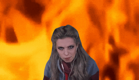a woman wearing headphones is standing in front of a fire background
