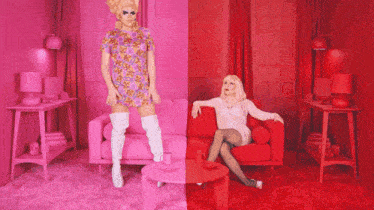 two drag queens are standing next to each other on a pink and red couch