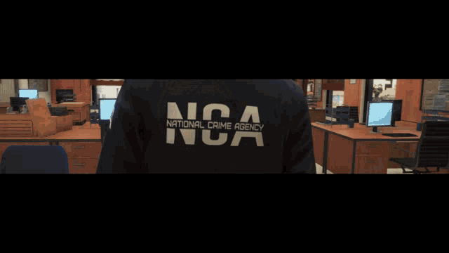 a man standing in front of a sign that says nca national crime agency