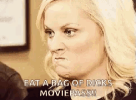 a woman is making a funny face and says eat a bag of dicks moviepass .