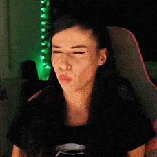 a woman is making a funny face while sitting in a chair .