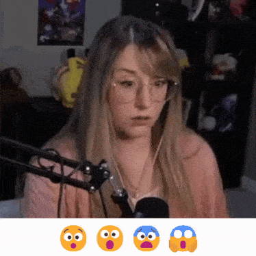a woman wearing glasses is sitting in front of a microphone with a surprised face on her face