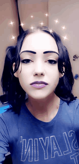 a woman wearing a blue shirt that says ' miya ' on it takes a selfie