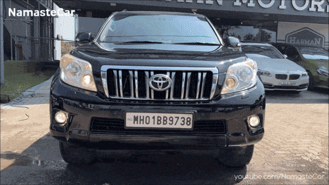 a black toyota is parked in front of a harman motors store