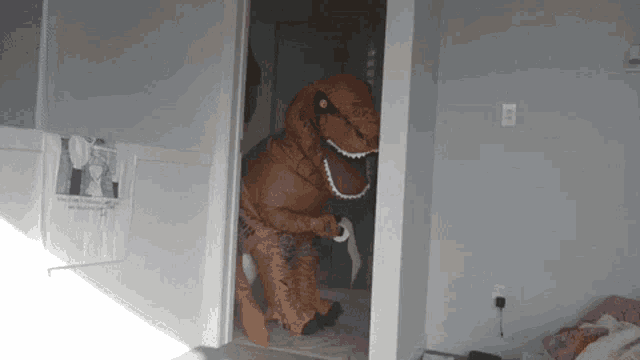 a person dressed in a t-rex costume is standing in a room
