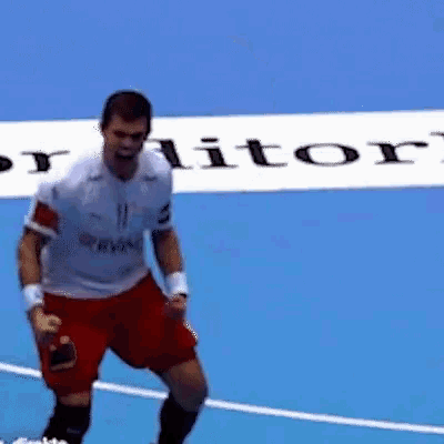 a man in a white shirt with the number 11 on it is standing on a blue court