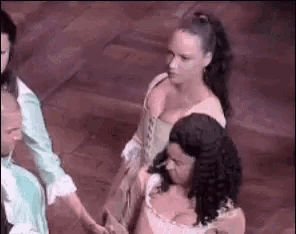 a group of people are standing next to each other holding hands on a stage .