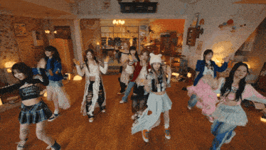 a group of girls are dancing in a room with a sign on the wall that says ' amanda ' on it