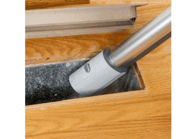 a vacuum cleaner is being used to clean a hole in the floor