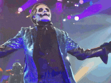 a man in a blue jacket with a skull face painted on his face