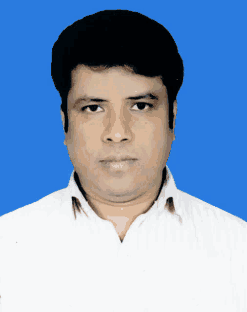 a man in a white shirt stands in front of a blue backdrop