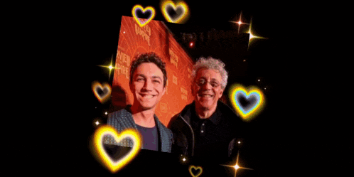 a man and a boy are surrounded by heart shaped lights on a black background
