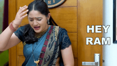 a woman in a blue saree is crying and says hey ram
