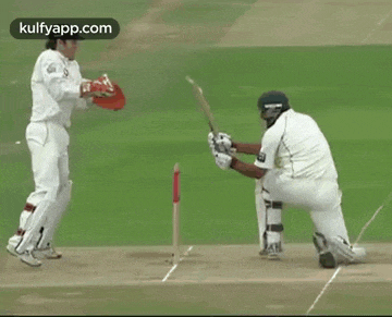 two cricket players on a field with the website kulfyapp.com on the bottom right