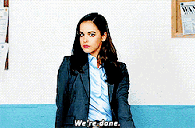 a woman in a suit and tie says " we 're done "