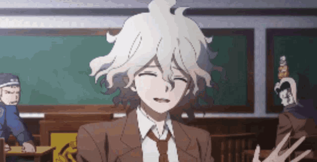 a man in a suit and tie is smiling in a classroom ..
